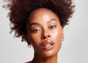 Model looking into the camera with glowing skin
